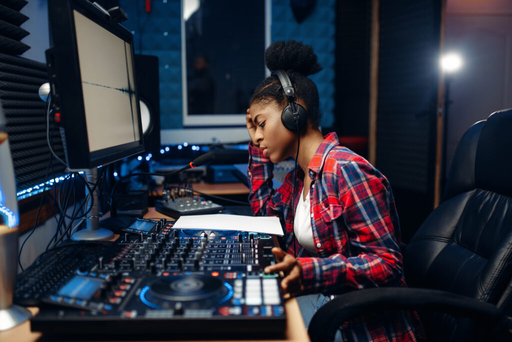 female sound operator in audio recording studio UWZG97C